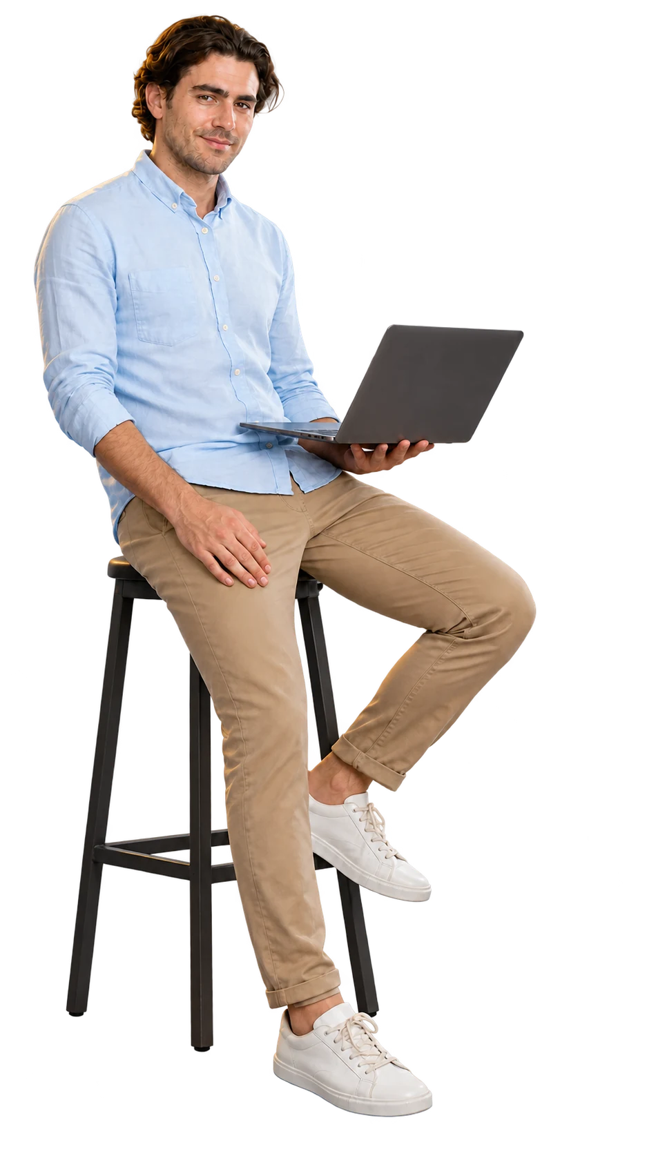 A relaxed customer seated on a stool with a laptop